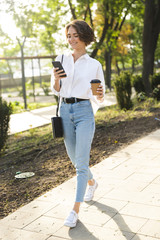 Smiling young woman walking at the street
