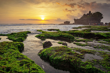 Sunset over Tanah Lot temple in Canggu, Bali, Indonesia.