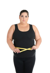 Overweight woman with measuring tape on white background