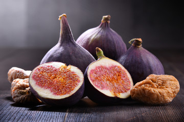 Composition with fresh and dried figs on wooden table
