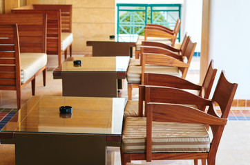 wooden tables and chairs stand on the street for rest