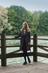 Girl in warm wool coat relaxing in city park