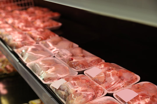 Shelf With Packed Chicken Meat In Supermarket