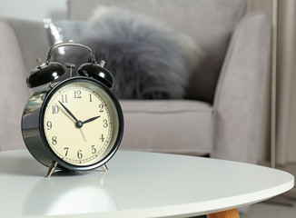 Alarm clock on table indoors, space for text. Time management