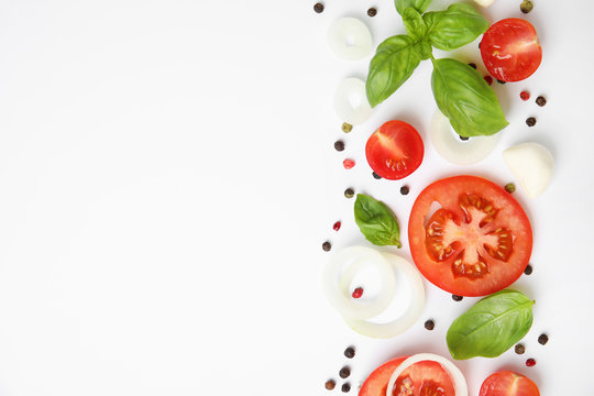 Fresh green basil leaves, tomatoes and mozzarella on white background, top view