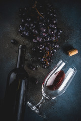 Wine bottle with glass and grapes