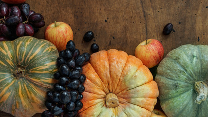 Autumn pumpkin harvest, grape and apples, empty blank space for design