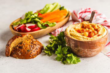 Classic chickpeas hummus in a wooden bowl.