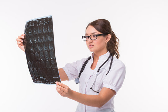 Young female doctor looking at x-ray image on white background. Mri scan, magnetic resonance, radiology concept