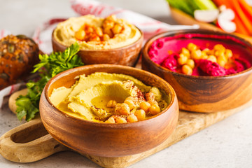 Different hummus bowls. Chickpea hummus, avocado hummus and beetroot hummus.