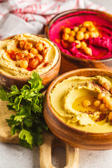 Different hummus bowls. Chickpea hummus, avocado hummus and beetroot hummus.