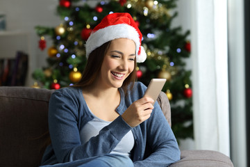 Woman checking phone messages in christmas