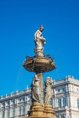 Fototapeta premium Beautiful topless girl as summit of State Opera fountain in Vienna in front of blue sky, Austria, details, closeup