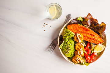 Vegan Rainbow bowl: vegetable meatballs, avocado, sweet potato and salad, top view.
