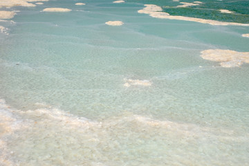 Texture of salt deposits in water. The Dead Sea dries up, the salvage of sea waters..