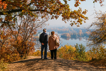 Fototapeta premium elderly couple in love looks at the view of the river and islands