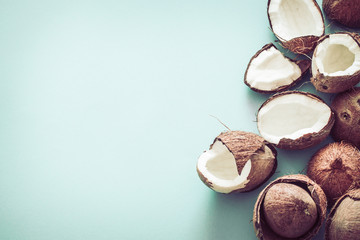 Fresh coconut halves on a blue background,