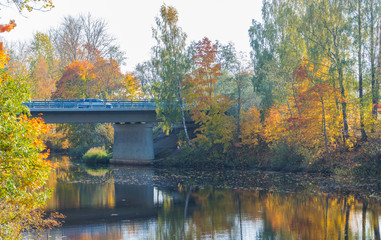 Fototapeta na wymiar Scenic view of the bridge on reinforced concrete piers on a sunny autumn day.