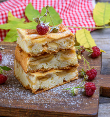 baked square pieces of apple pie are stacked