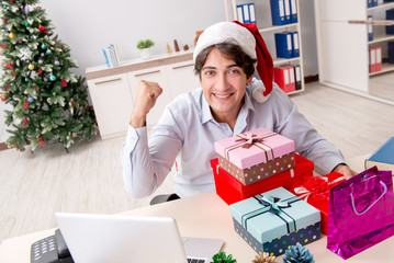 Young employee businessman in office christmas concept