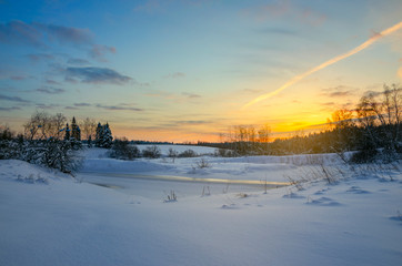 Fototapeta na wymiar Frosty winter landscape with frozen ice bound river.