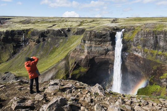 Photographer taking picture of Haifoss waterfall, Iceland