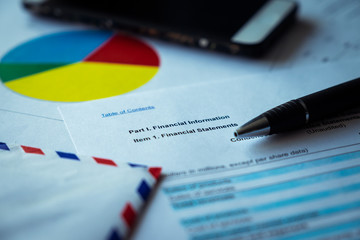 Financial statement on brown envelope and eyeglass, business concept