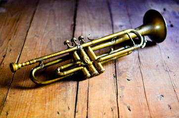 an old trumpet on an old wooden table