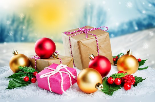 Christmas winter background with gifts, colored balls and christmas branches