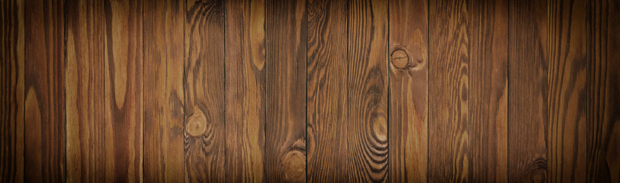 Dark brown boards, panoramic background of a wooden texture