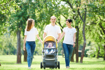 family walking with children in summer park. happy parenting