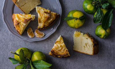 tangerine cake on the grey stone background, top view, flat lay 
