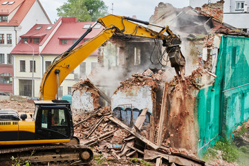 excavator crasher machine at demolition on construction site