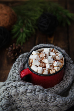 red Cup with marshmallow on wooden new year background
