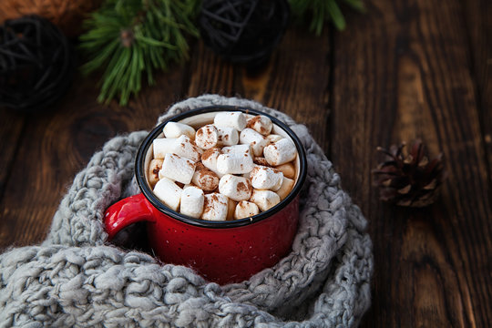 red Cup with marshmallow on wooden new year background