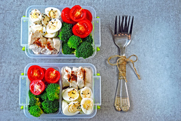 box with a healthy meal. Keto lunch to go. Chicken breast, broccoli, quail eggs, cherry tomatoes. An example of a snack on keto diet.