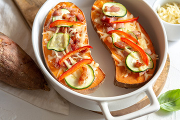 Baked sweet potato with bacon, sour cream, zucchini, red pepper and cheddar cheese.