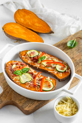 Baked sweet potato with bacon, sour cream, zucchini, red pepper and cheddar cheese.