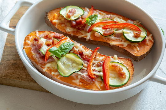 Baked sweet potato with bacon, sour cream, zucchini, red pepper and cheddar cheese.