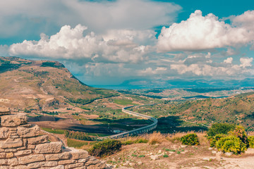 Naklejka premium High-speed road, long bridge. Stunning views of the valley of the green valley, the sea and high mountains. Sicily, Italy