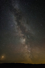 Bright milky way on a summer night through the clouds