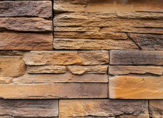 Sandstone. For interior and exterior decoration. The background is colorful.Yellow. Brown. Gray.