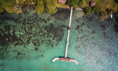 Drone shopp from above of wooden pier dock in beautiful  Mexican lagoon Baclar 