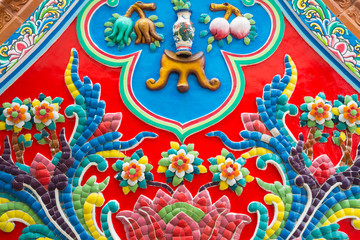 Beautiful detail of handmade Chinese style flower ceramic mosaic tile background in Chinese temple