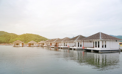 Fototapeta premium Raft House floating on the river with mountain at kanchanaburi, Resort in thailand.