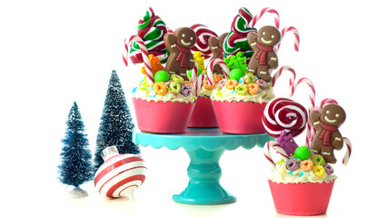 On-trend candyland festive Christmas cupcakes on white background.