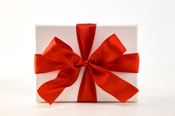 White gift box with red ribbon bow