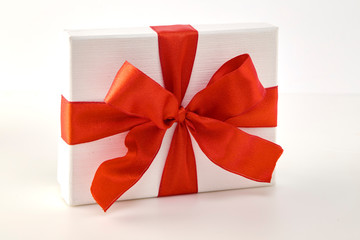White gift box with red ribbon bow
