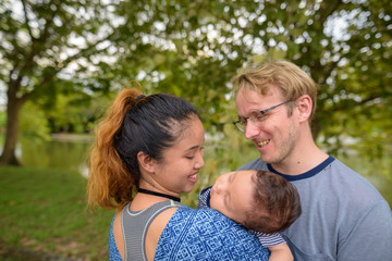 Multi-ethnic young family bonding together at the park