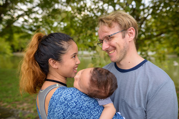 Fototapeta premium Multi-ethnic young family bonding together at the park
